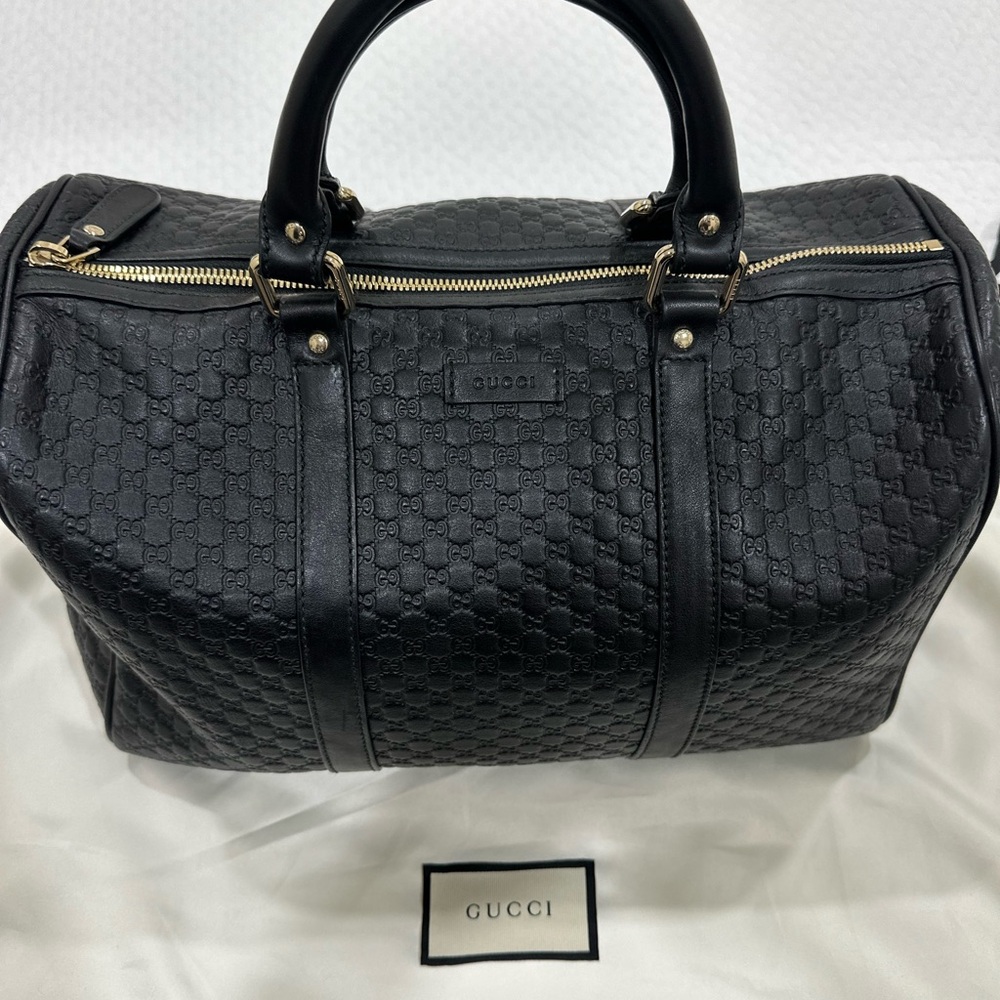 Gucci Black Leather Travel Bag with Gold Accents